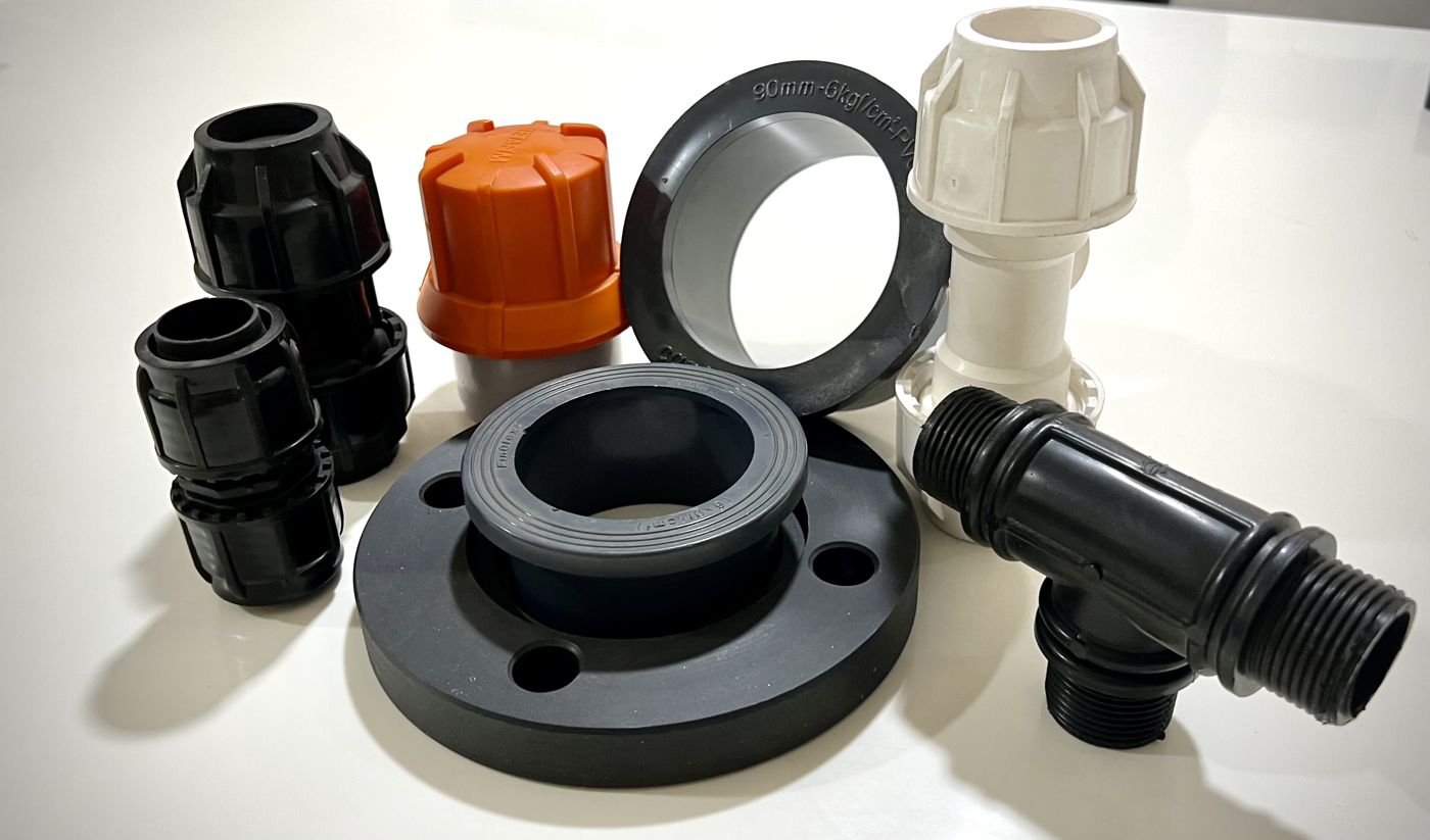 Stack of black injection molded compression fittings
